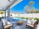 A beautifully designed backyard features a refreshing pool and stylish outdoor seating area perfect for relaxation at 159 Antilla Dr, Rotonda West, FL 33947