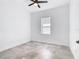 Clean and modern bedroom with tile floors, ceiling fan, and window at 159 Antilla Dr, Rotonda West, FL 33947