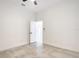Bright bedroom featuring tile floors, a fan, and white walls with an open door at 159 Antilla Dr, Rotonda West, FL 33947