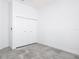 Bedroom with gray tile floors, modern ceiling light, and spacious closet at 159 Antilla Dr, Rotonda West, FL 33947