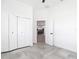 This modern bedroom features tile floors and a view into the home's kitchen at 159 Antilla Dr, Rotonda West, FL 33947