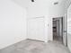 This bedroom has white walls, gray tile floors, and a closet at 159 Antilla Dr, Rotonda West, FL 33947