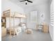 Bright bedroom with a wooden bunk bed, desk, chair, and modern ceiling fan at 159 Antilla Dr, Rotonda West, FL 33947