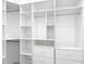 Custom closet featuring white shelving, drawers, and hanging rods at 159 Antilla Dr, Rotonda West, FL 33947