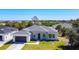 Charming home showcasing a modern facade with a well-manicured lawn, a grey roof, and a dark colored garage door at 159 Antilla Dr, Rotonda West, FL 33947