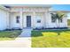 Close-up of the front entrance with stone accents, pillars, and a modern front door at 159 Antilla Dr, Rotonda West, FL 33947