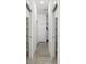 Hallway with tile floors, closet doors, and a view into a well-lit space at 159 Antilla Dr, Rotonda West, FL 33947