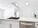 Contemporary kitchen island with stainless dishwasher, quartz countertops, and pendant lighting at 159 Antilla Dr, Rotonda West, FL 33947