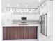 Modern kitchen with white cabinets, a stylish island with seating, stainless steel appliances, and pendant lighting at 159 Antilla Dr, Rotonda West, FL 33947