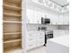 New kitchen includes pantry, white cabinets, quartz countertops, and modern stainless steel appliances at 159 Antilla Dr, Rotonda West, FL 33947