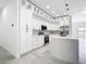 Spacious kitchen featuring white cabinetry, stainless steel appliances, and stylish backsplash, with an island at 159 Antilla Dr, Rotonda West, FL 33947