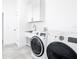 Well-appointed laundry room featuring a sink, cabinets, and state-of-the-art washer and dryer at 159 Antilla Dr, Rotonda West, FL 33947