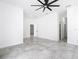 Spacious living room with neutral tile floors, modern ceiling fan, and white walls at 159 Antilla Dr, Rotonda West, FL 33947