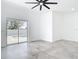 Open living space with gray tile floors leading to a pool view through sliding glass doors at 159 Antilla Dr, Rotonda West, FL 33947