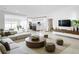 Bright living room features a modern sectional, stylish rug, and open layout with kitchen views at 159 Antilla Dr, Rotonda West, FL 33947