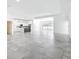 Spacious open floorplan with modern tile, white walls, and an island kitchen in the background at 159 Antilla Dr, Rotonda West, FL 33947