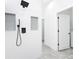 Modern shower with grey tile, black shower head, and large glass door at 159 Antilla Dr, Rotonda West, FL 33947