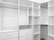 Bright walk-in closet offering abundant storage with multiple shelves, drawers, and hanging space for clothing and accessories at 159 Antilla Dr, Rotonda West, FL 33947