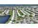Extensive aerial perspective of a community with a peaceful lake, pools, and landscaping at 6522 11Th W Ave, Bradenton, FL 34209