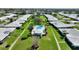 Aerial view of a charming community featuring a community pool, lush green landscaping, and beautiful single story homes at 6522 11Th W Ave, Bradenton, FL 34209