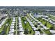Expansive aerial shot of a community featuring white-roofed homes and a beautiful lake at 6522 11Th W Ave, Bradenton, FL 34209