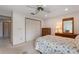 Bright bedroom featuring neutral carpet, ceiling fan, and large wardrobe closet at 6522 11Th W Ave, Bradenton, FL 34209