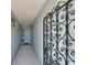 Inviting entryway featuring a decorative security gate, tiled flooring, and a light-blue door creating a pleasant transition at 6522 11Th W Ave, Bradenton, FL 34209