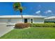 Charming single-story home with a well-manicured lawn and a swaying palm tree in a sunny, cheerful setting at 6522 11Th W Ave, Bradenton, FL 34209