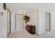 Elegant foyer showcasing tiled flooring, a dark wooden accent table, and wallpaper creating a warm, inviting atmosphere at 6522 11Th W Ave, Bradenton, FL 34209