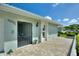Welcoming front entrance features a decorative security gate, light-blue siding, and mature landscaping around the walkway at 6522 11Th W Ave, Bradenton, FL 34209