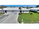 Inviting single-story home showcasing a well-kept lawn, concrete driveway, and tiled roof in a serene community at 6522 11Th W Ave, Bradenton, FL 34209