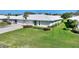 A picturesque single-story residence features lush green lawn and a concrete driveway, promising comfortable living at 6522 11Th W Ave, Bradenton, FL 34209