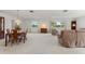 Open-concept living area with a large dining table, plush seating, and bright natural light at 6522 11Th W Ave, Bradenton, FL 34209