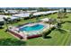 A luxurious community pool is surrounded by lounge chairs and tables to provide resort-style relaxation at 6522 11Th W Ave, Bradenton, FL 34209