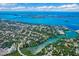 Breathtaking aerial shot capturing a vibrant residential area near the bay, featuring lush trees and tranquil waterways at 1724 Harbor Dr, Clearwater, FL 33755