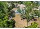 Aerial view of the home surrounded by mature trees at 1724 Harbor Dr, Clearwater, FL 33755
