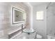 Bathroom featuring clear glass sink, granite counters, and sleek lighting at 1724 Harbor Dr, Clearwater, FL 33755