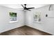 Bedroom featuring two windows, hardwood floors, and a ceiling fan at 1724 Harbor Dr, Clearwater, FL 33755