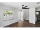 Bedroom featuring dark hardwood floors, ceiling fan, and a large window at 1724 Harbor Dr, Clearwater, FL 33755