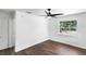 Bright bedroom with hardwood floors, a ceiling fan, and a window at 1724 Harbor Dr, Clearwater, FL 33755