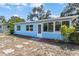 Cozy one-story blue house with bright windows and a neatly landscaped front yard at 1724 Harbor Dr, Clearwater, FL 33755