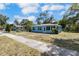 Quaint one-story blue house with a well-lit sunroom and sidewalk to street at 1724 Harbor Dr, Clearwater, FL 33755