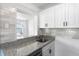 Bright kitchen featuring gray granite countertops and modern stainless steel faucet at 1724 Harbor Dr, Clearwater, FL 33755