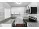 Recently updated kitchen with gray backsplash, granite countertops, and stainless steel appliances at 1724 Harbor Dr, Clearwater, FL 33755