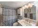 Well-lit bathroom featuring a striped shower curtain, vanity with a white countertop, and modern fixtures at 5501 80Th N St # 201, St Petersburg, FL 33709