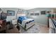 Nautical-themed bedroom with a comfortable bed, bright window, and views of the computer desk at 5501 80Th N St # 201, St Petersburg, FL 33709