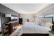 Spacious bedroom with a large bed, dark accent wall, and natural light from the window at 5501 80Th N St # 201, St Petersburg, FL 33709
