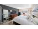Well-lit bedroom showcasing a plush bed, dark accent wall, hardwood floors, and ample natural light at 5501 80Th N St # 201, St Petersburg, FL 33709