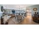 Open-concept dining area features a round table, decorative rug, and a mirrored wall reflecting the living space at 5501 80Th N St # 201, St Petersburg, FL 33709