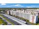 Exterior shot of a multi-story building with covered parking and manicured grounds at 5501 80Th N St # 201, St Petersburg, FL 33709